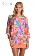 Model is wearing an orange multicolored tropical printed short sleeve tunic cover up from our Sunshine 79 brand.