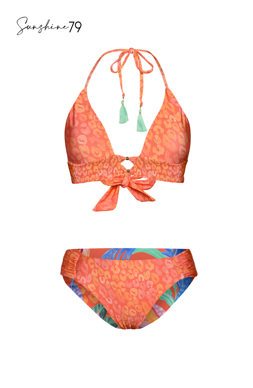 Model is wearing an orange multicolored tropical printed reversible side shirred hipster bikini bottom from our Sunshine 79 brand.