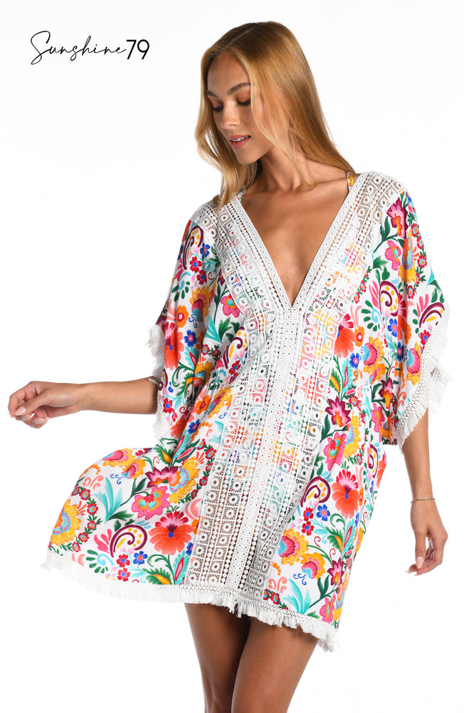 Model is wearing a multicolored spanish inspired printed v neck caftan cover up from our Sunshine 79 brand.