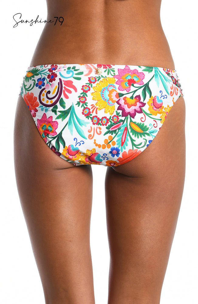 Model is wearing a multicolored spanish inspired printed side shirred hipster bikini bottom from our Sunshine 79 brand.
