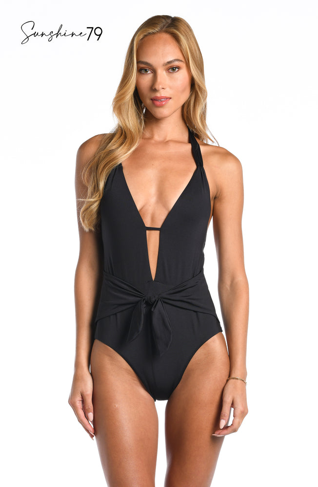 Model is wearing a solid black colored halter plunge one piece from our Sunshine 79 brand.