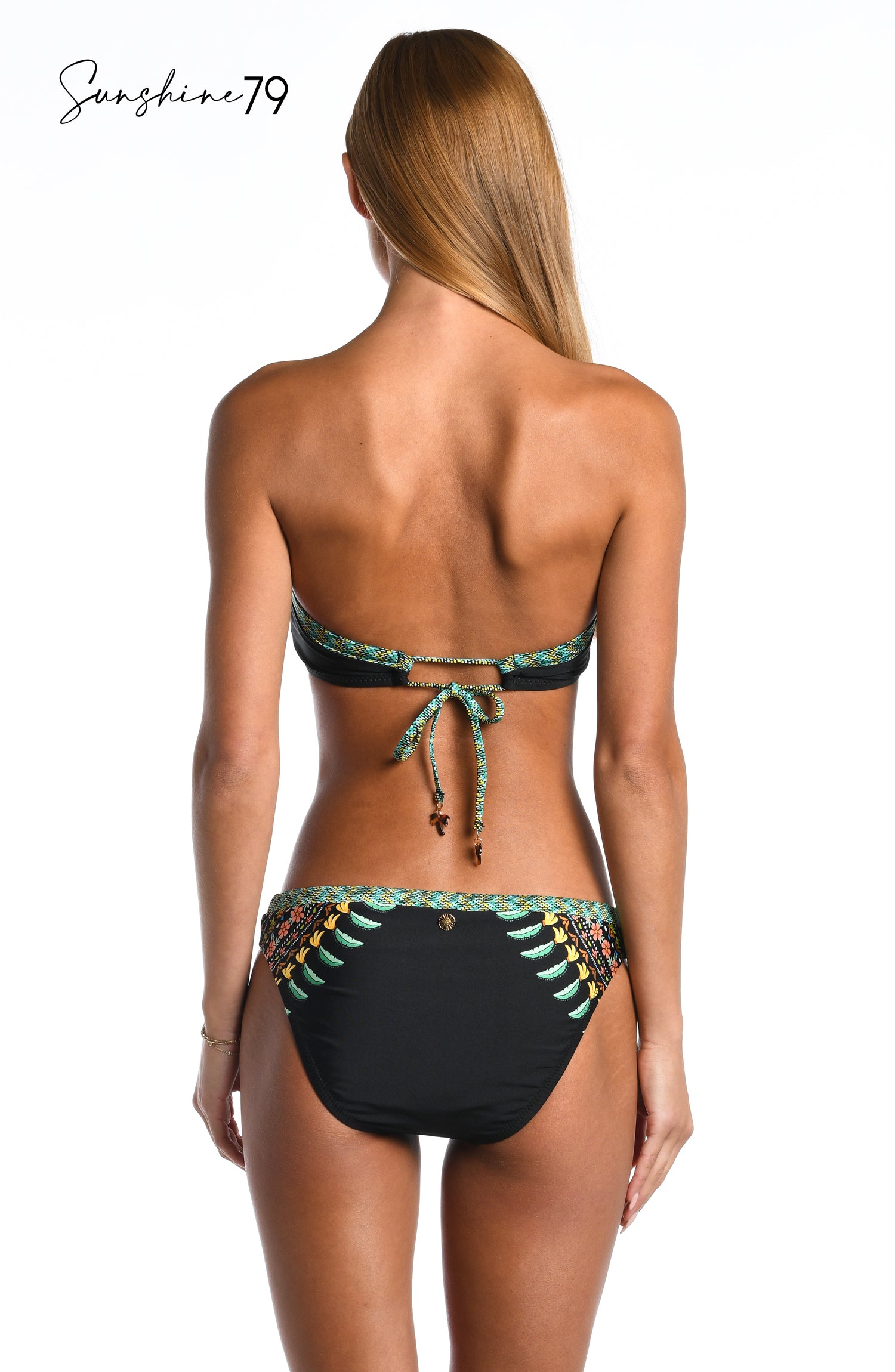 Model is wearing a black multicolored palm tree printed front twist bandeau bikini top from our Sunshine 79 brand.