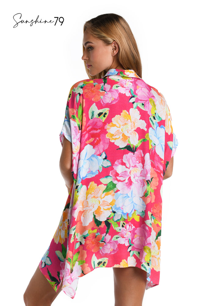 Model is wearing a colorful floral resort shirt cover up from the Sunshine 79 Expressive Garden Collection