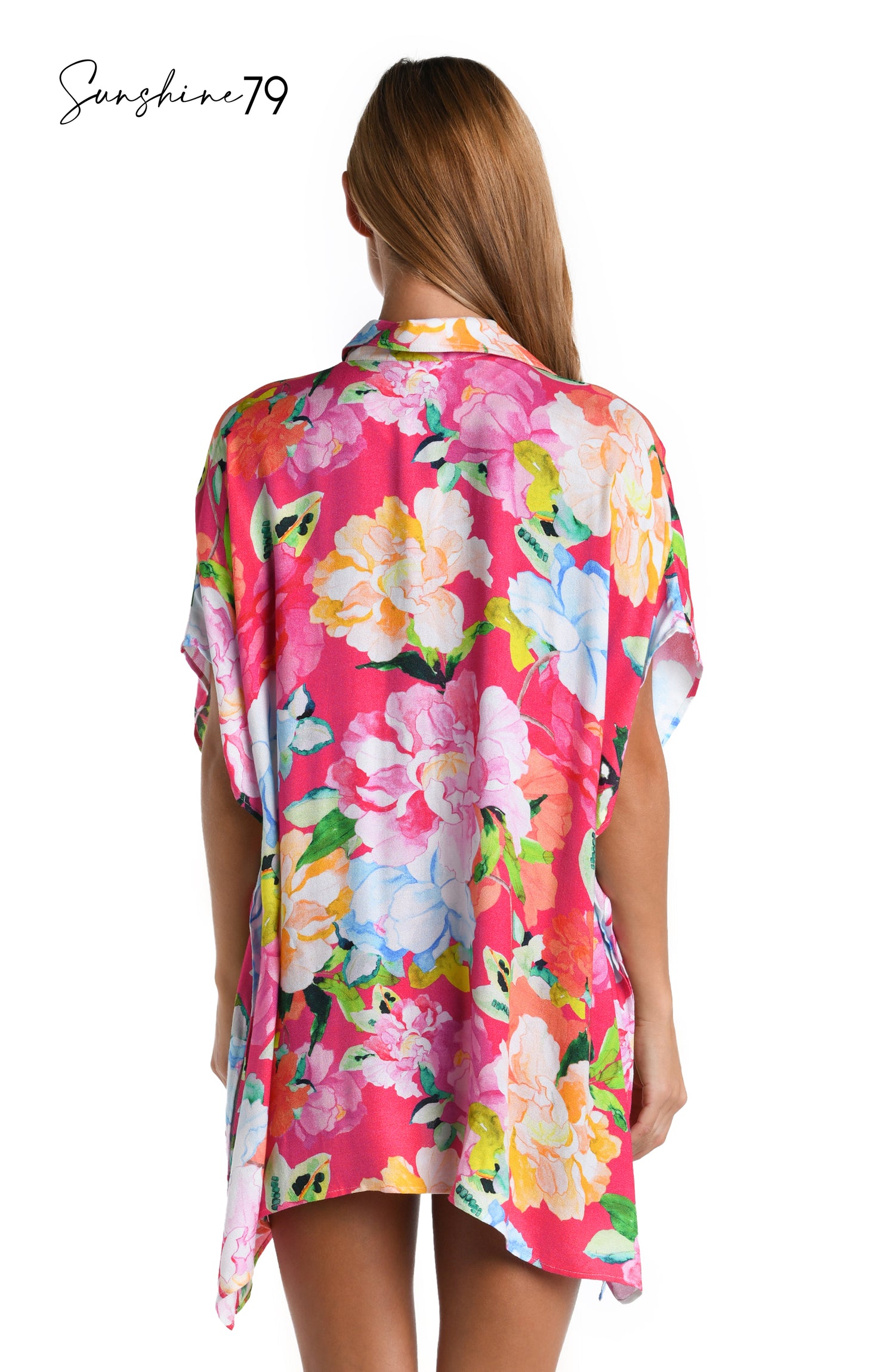 Model is wearing a colorful floral resort shirt cover up from the Sunshine 79 Expressive Garden Collection