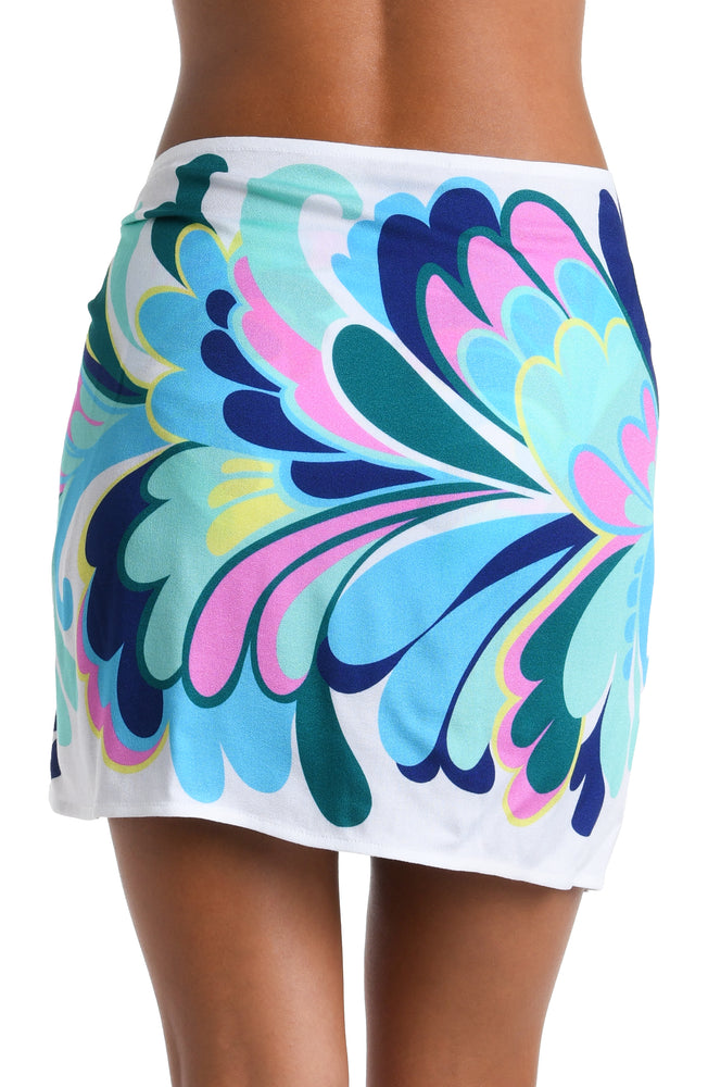 Model is wearing a white, blue, green, and pink multicolored floral printed Short Pareo Wrap