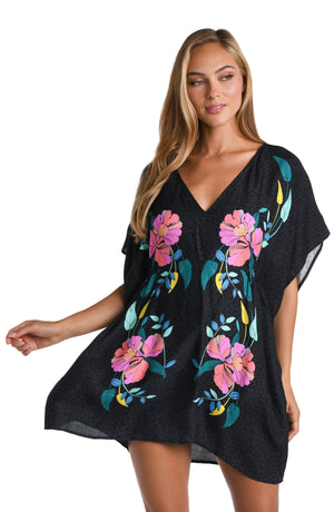 Model is wearing a black, pink, and green multicolored floral patterned V-Neck Tunic