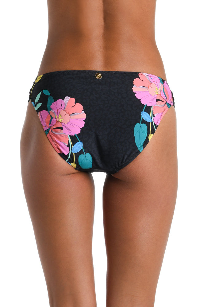 Model is wearing a black, pink, and green multicolored floral patterned Side Shirred Hipster Bottom