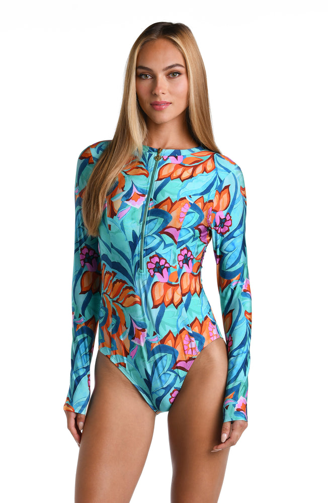 Model is wearing a turquoise, blue, coral multicolored floral printed Paddlesuit One Piece