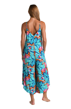 Model is wearing a turquoise, blue, coral multicolored floral printed Jumpsuit Cover Up