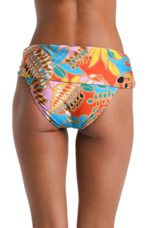 Model is wearing a pink, orange, blue, and yellow multicolored tropical printed Sash Hipster Bottom