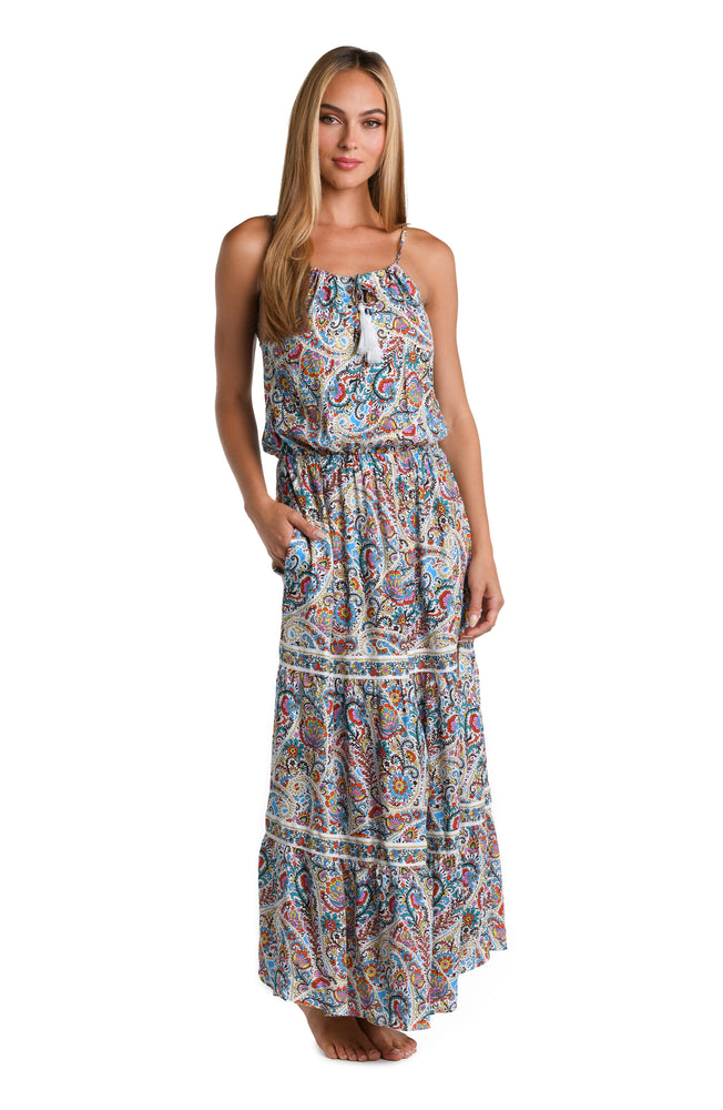 Model is wearing a white, red, blue, green, and yellow multicolored paisley printed Maxi Dress