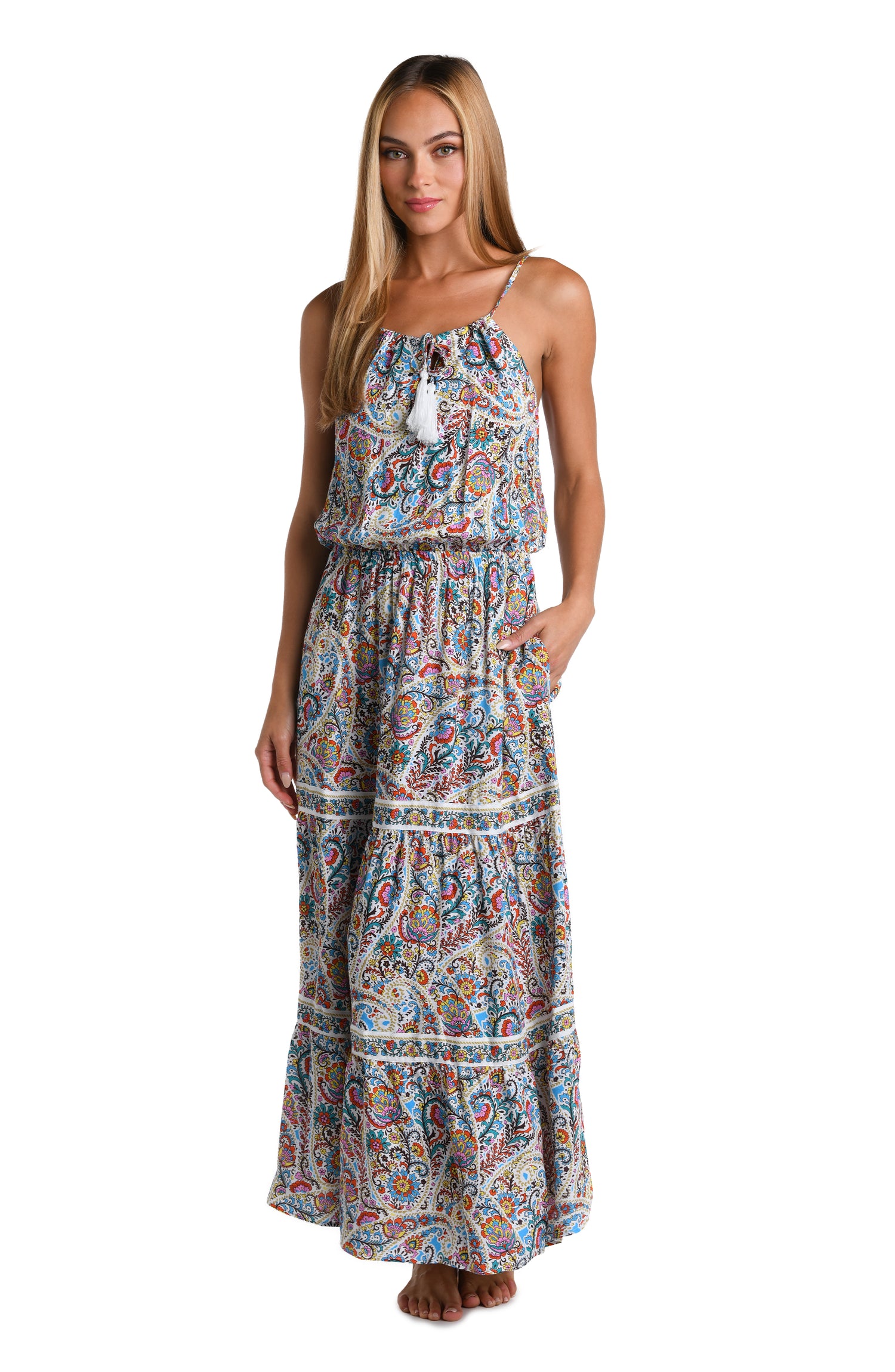Model is wearing a white, red, blue, green, and yellow multicolored paisley printed Maxi Dress