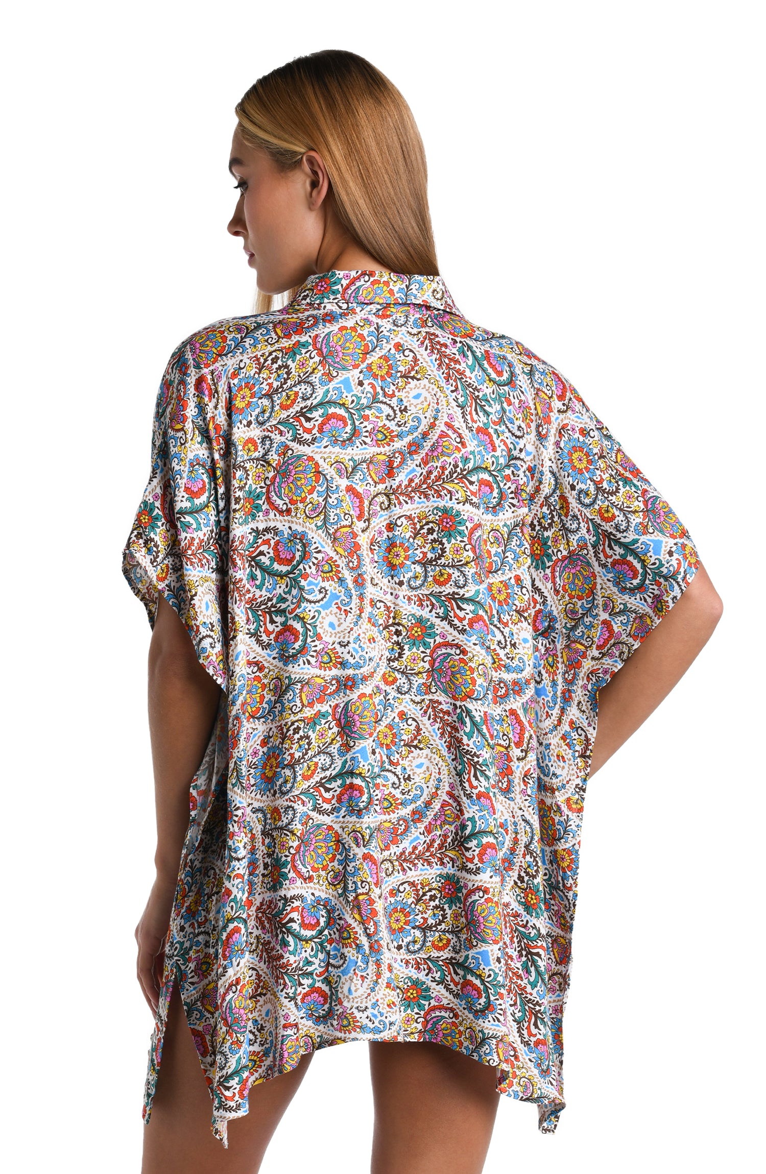 Model is wearing a white, red, blue, green, and yellow multicolored paisley printed Resort Shirt Cover Up