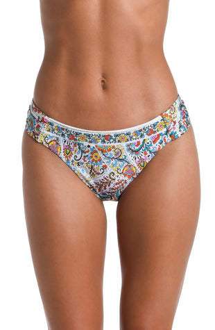 Model is wearing a white, red, blue, green, and yellow multicolored paisley printed Side Shirred Hipster Bottom