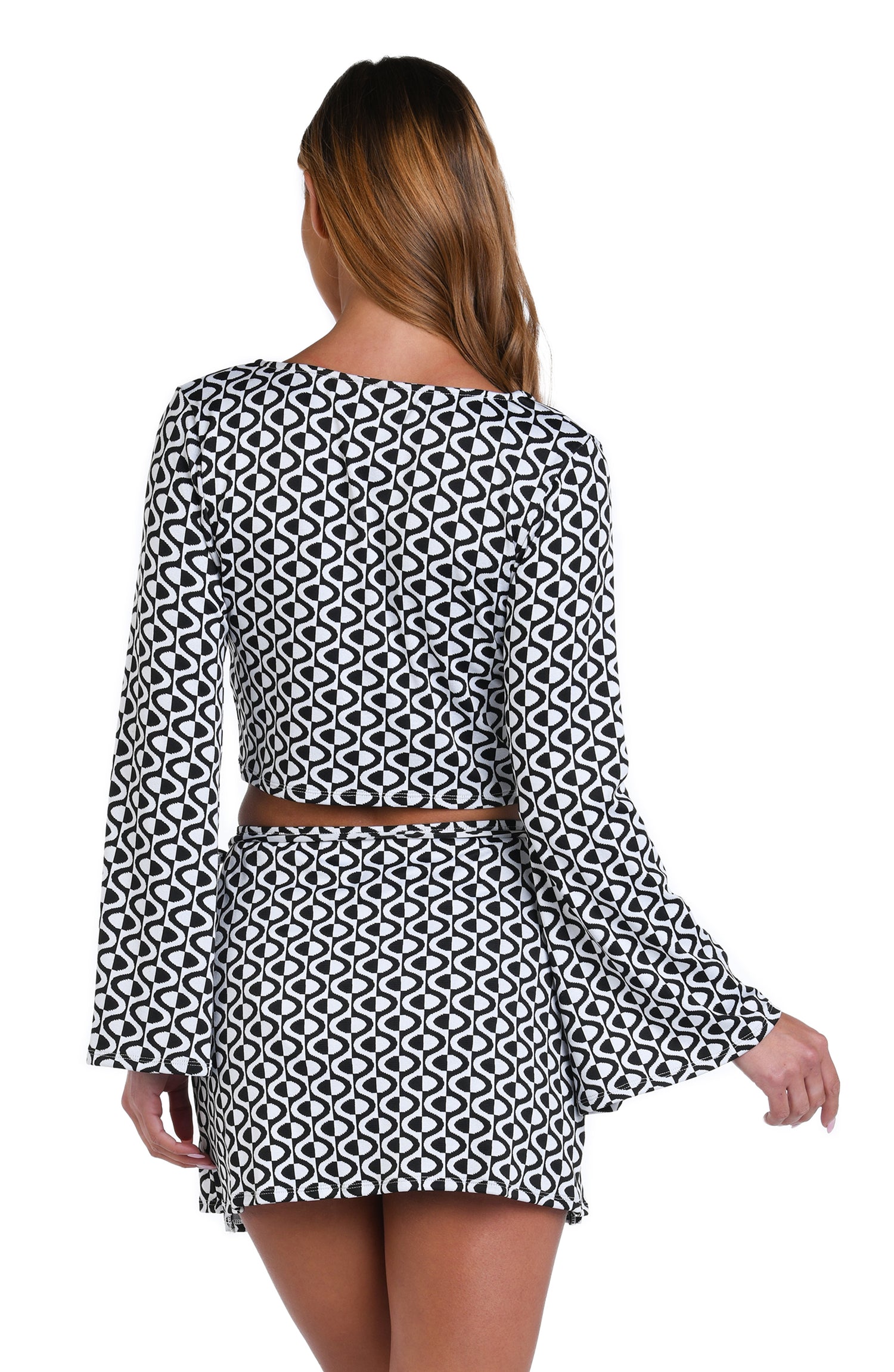 Model is wearing a black and white geometric patterned Crop Top Cover Up