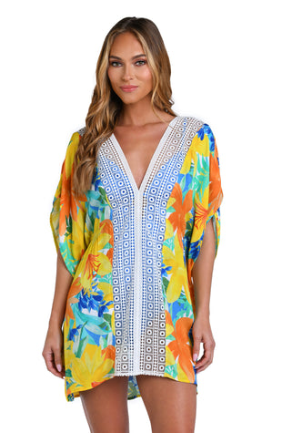 Model is wearing a blue, green, and orange multi colored floral printed tunic swimsuit cover up.