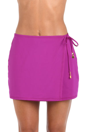 Front image of model wearing a Sunshine 79 Sunshine Solids Wrap Skirt Cover Up in Bright Violet.