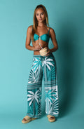 Image of model wearing tropical patterned pants and a turquoise bikini top