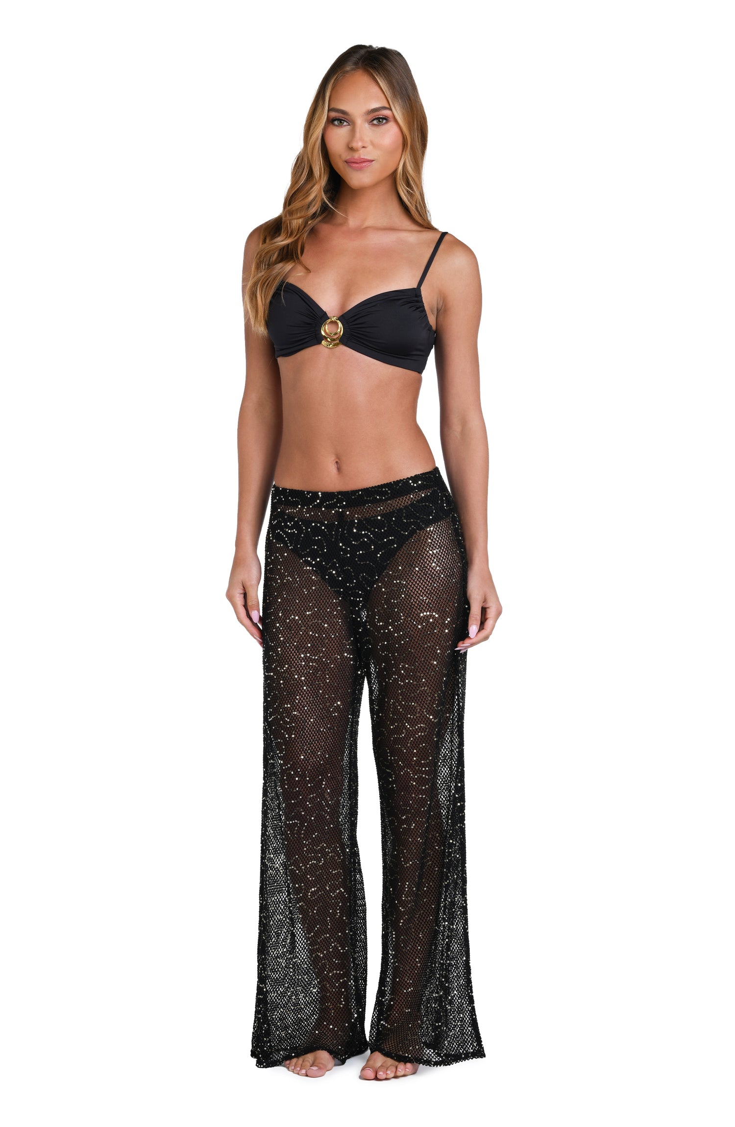 Model is wearing a black colored sheer beach pant cover up.