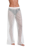 Model is wearing a white colored sheer beach pant cover up.