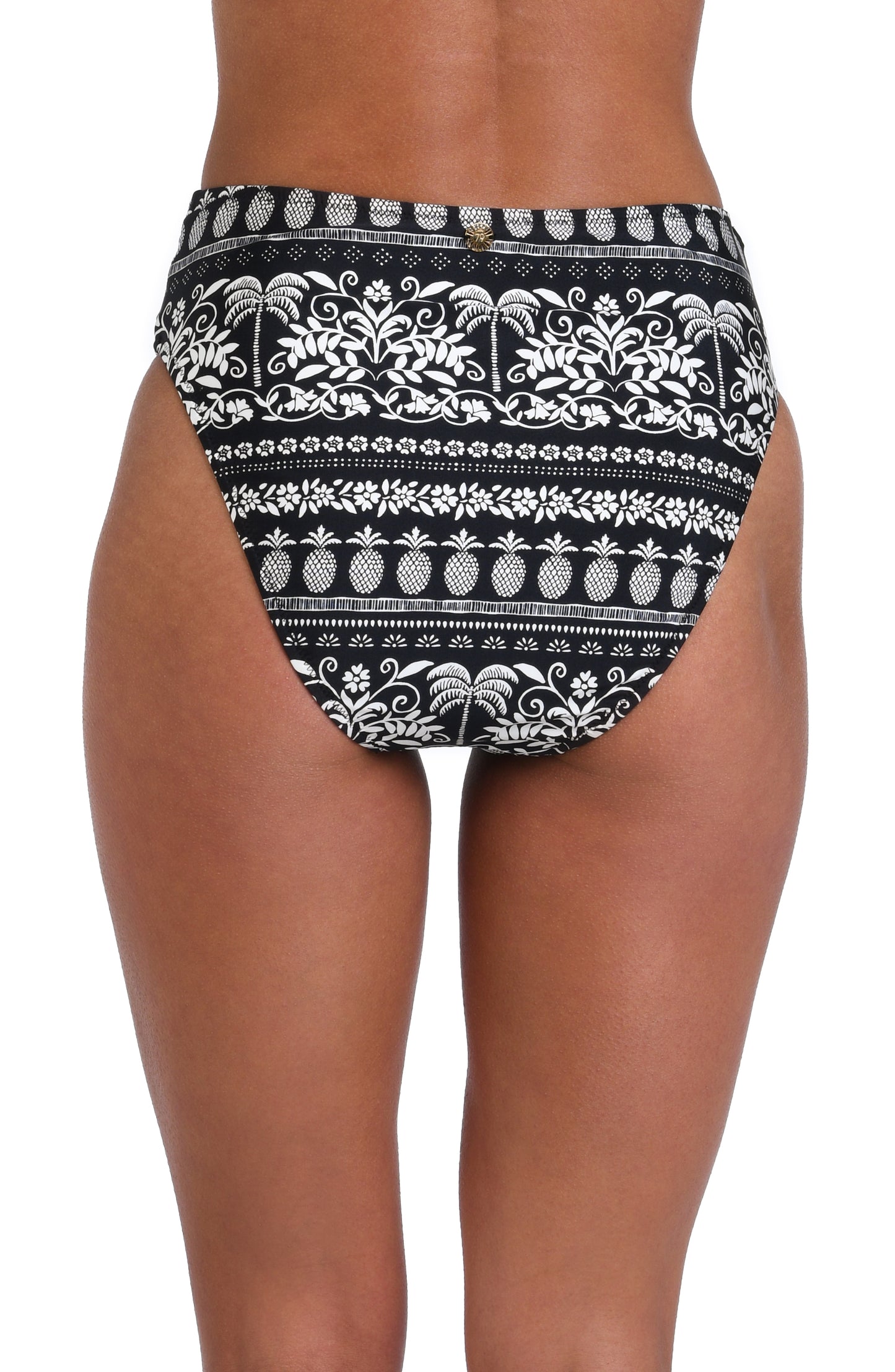 Model is wearing a black and white monochromatic patterned belted high waist swimsuit bottom that features an allover tropical motif with hints of palm trees and pineapples set against a black background.