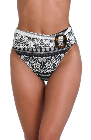 Model is wearing a black and white monochromatic patterned belted high waist swimsuit bottom that features an allover tropical motif with hints of palm trees and pineapples set against a black background.