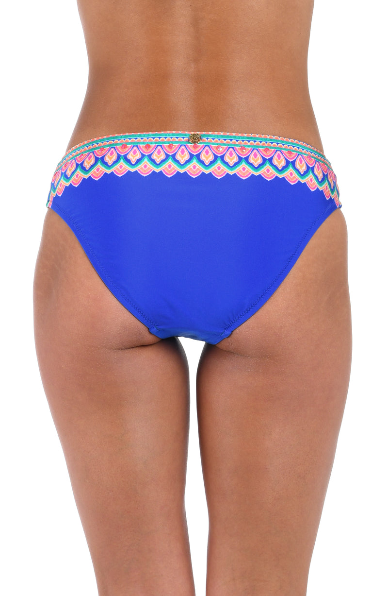 Back image of model wearing the Jewel Essence Hipster Bottom in an indigo multi colored geometric print.