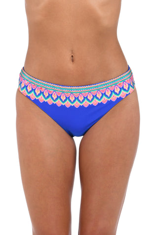 Front image of model wearing the Jewel Essence Hipster Bottom in an indigo multi colored geometric print.