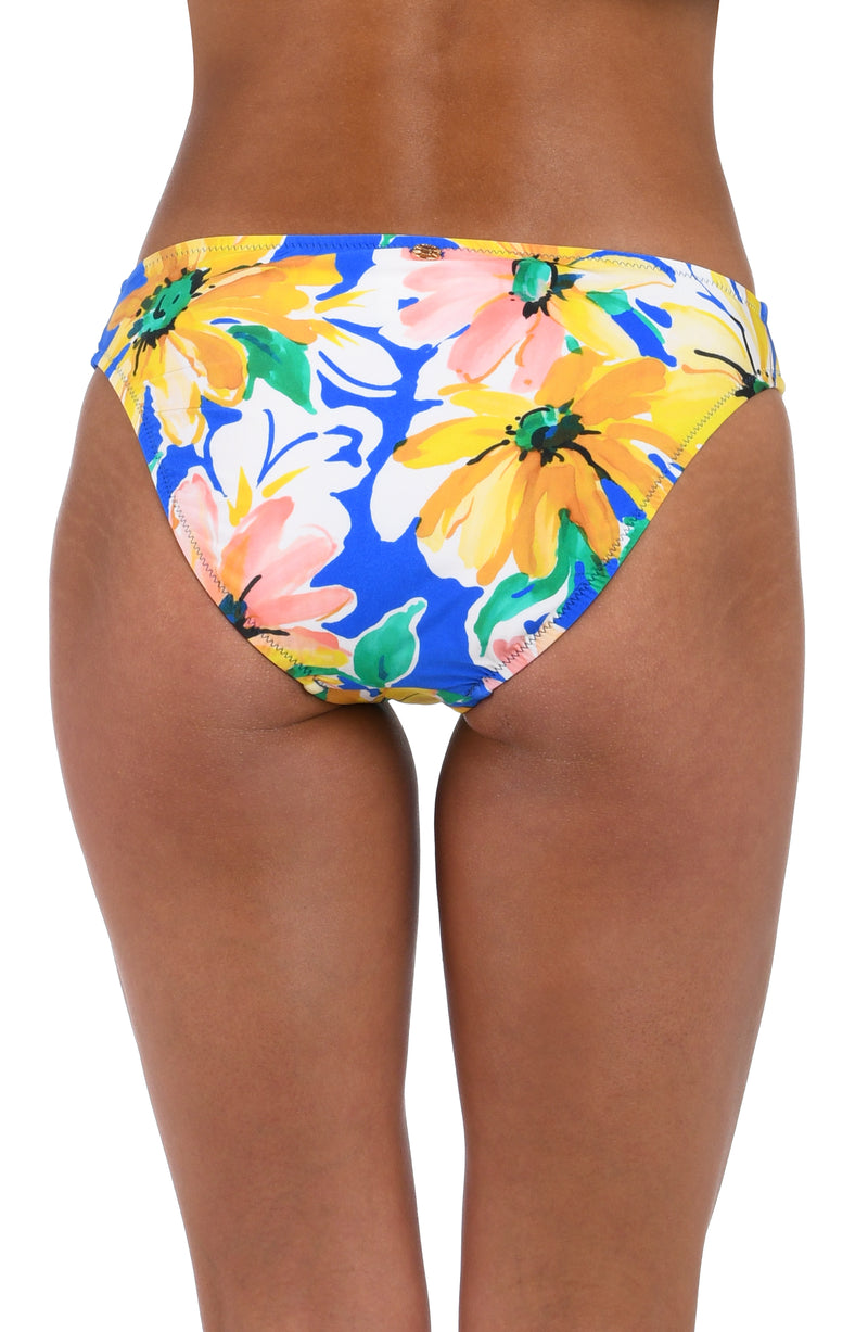 Back image of model wearing the Sunflower Getaway Hipster Bottom in a multi colored tropical print.