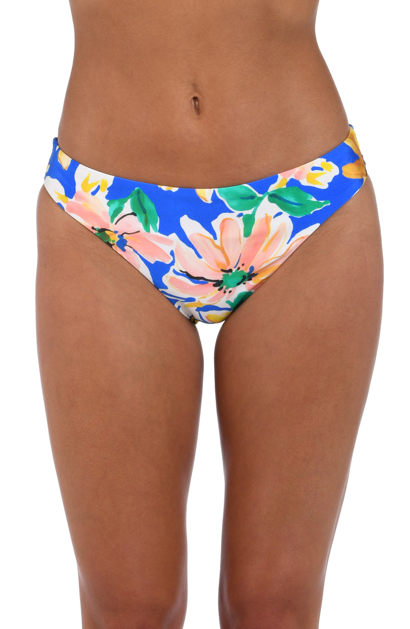 Front image of model wearing the Sunflower Getaway Hipster Bottom in a multi colored tropical print.