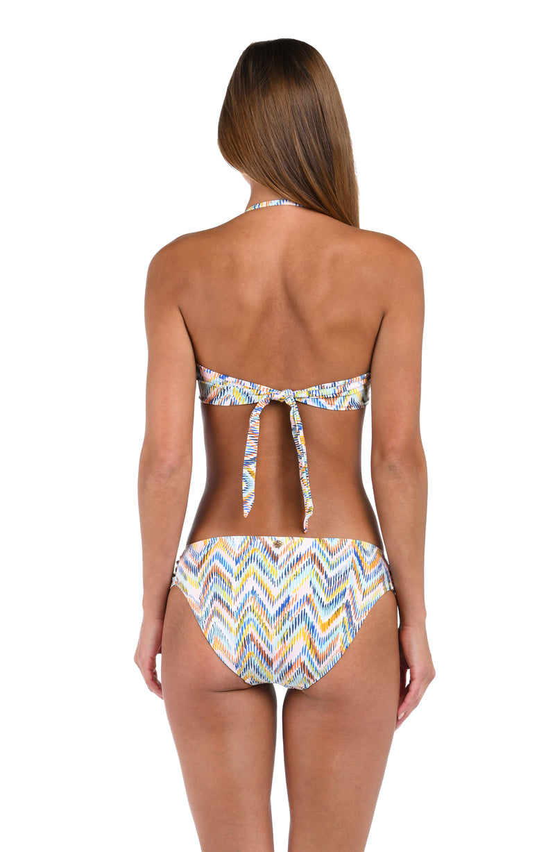 Back image of model wearing the Soul Wave  Bandeau Bikini Top in white multi colored geometrical print.