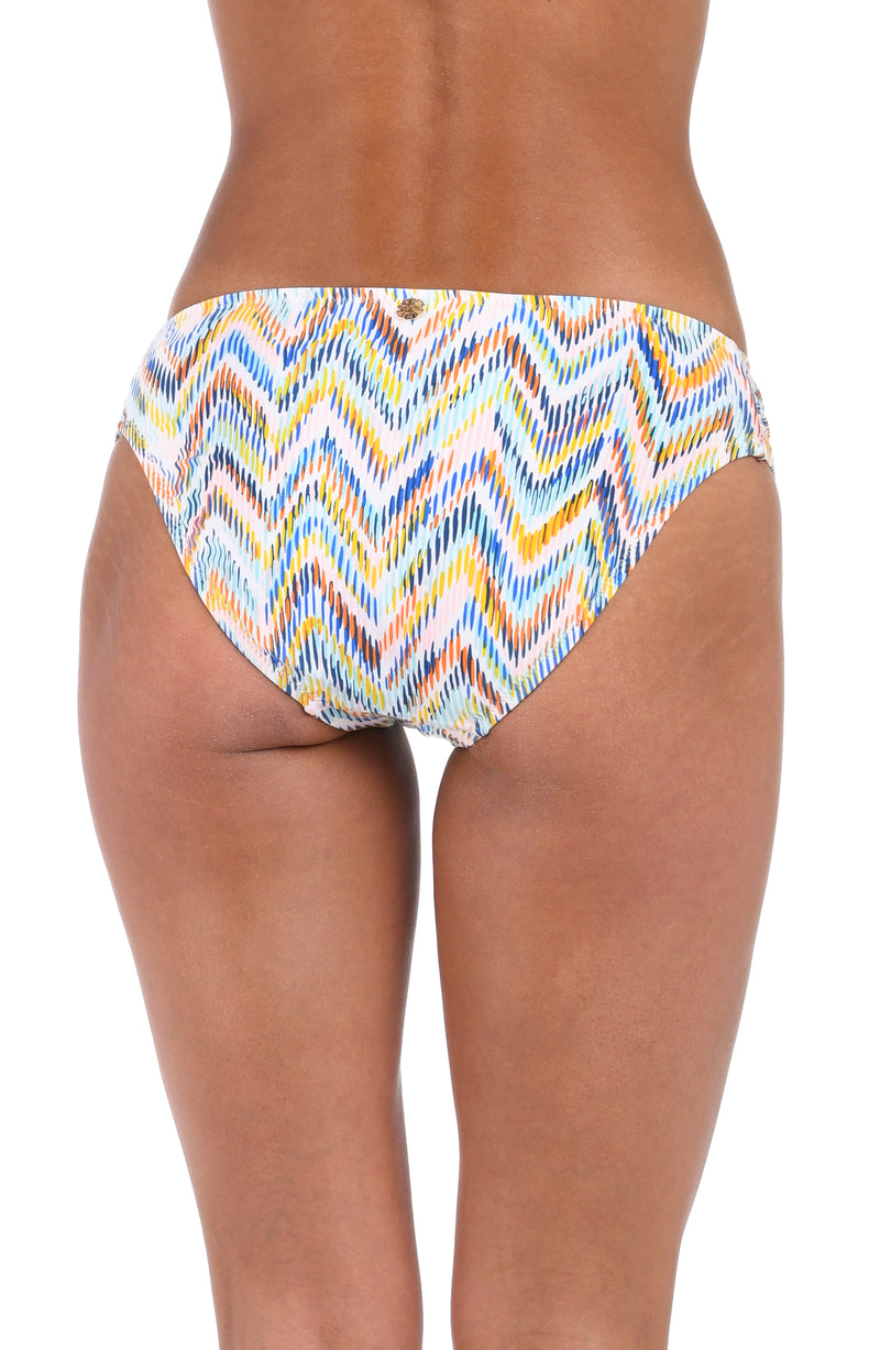 Back image of model wearing the Soul Wave  Side Shirred Hipster Bottom in white multi colored geometrical print.