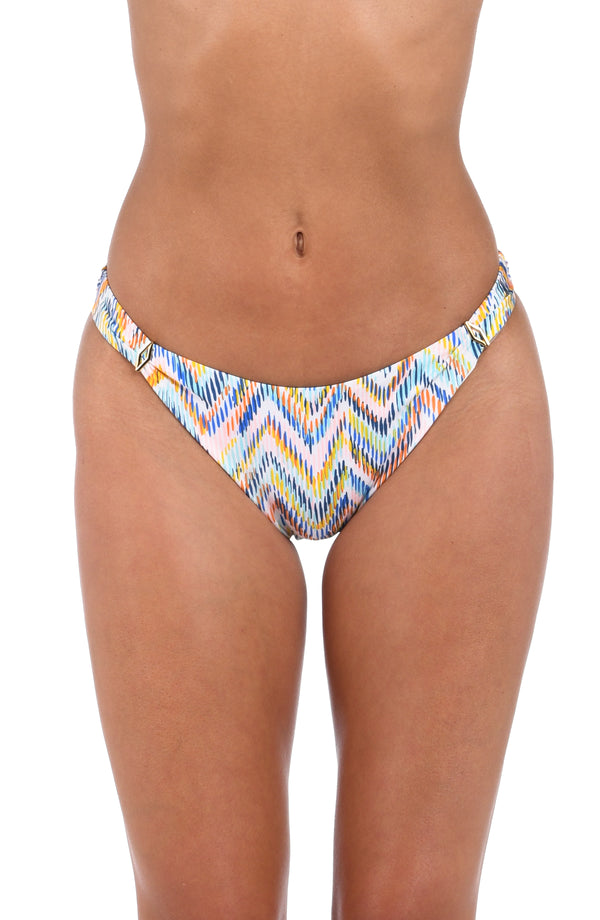 Front image of model wearing the Soul Wave  French Cut Bikini Bottom in white multi colored geometrical print.