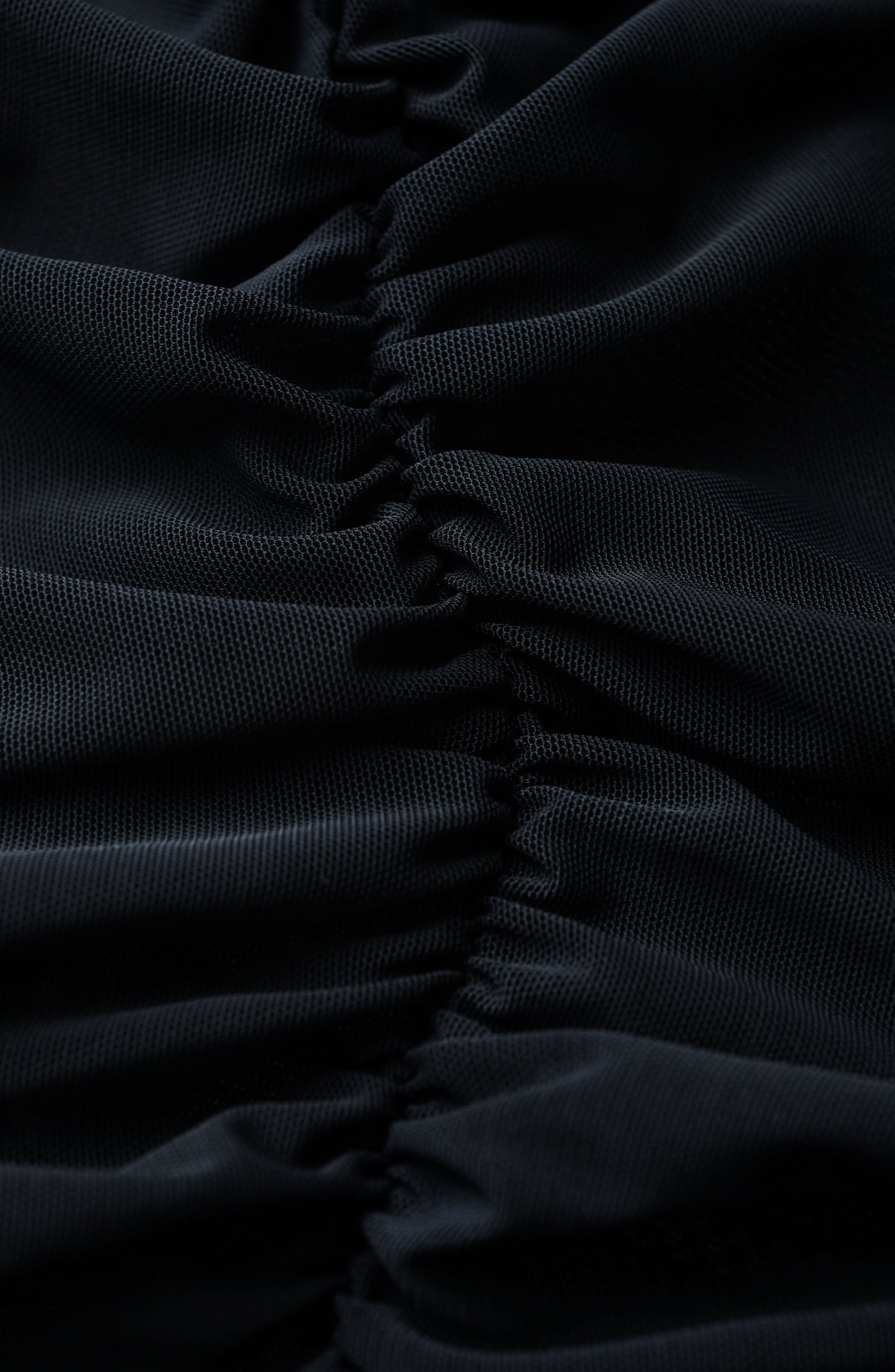 Close-up of black fabric with a ruched texture