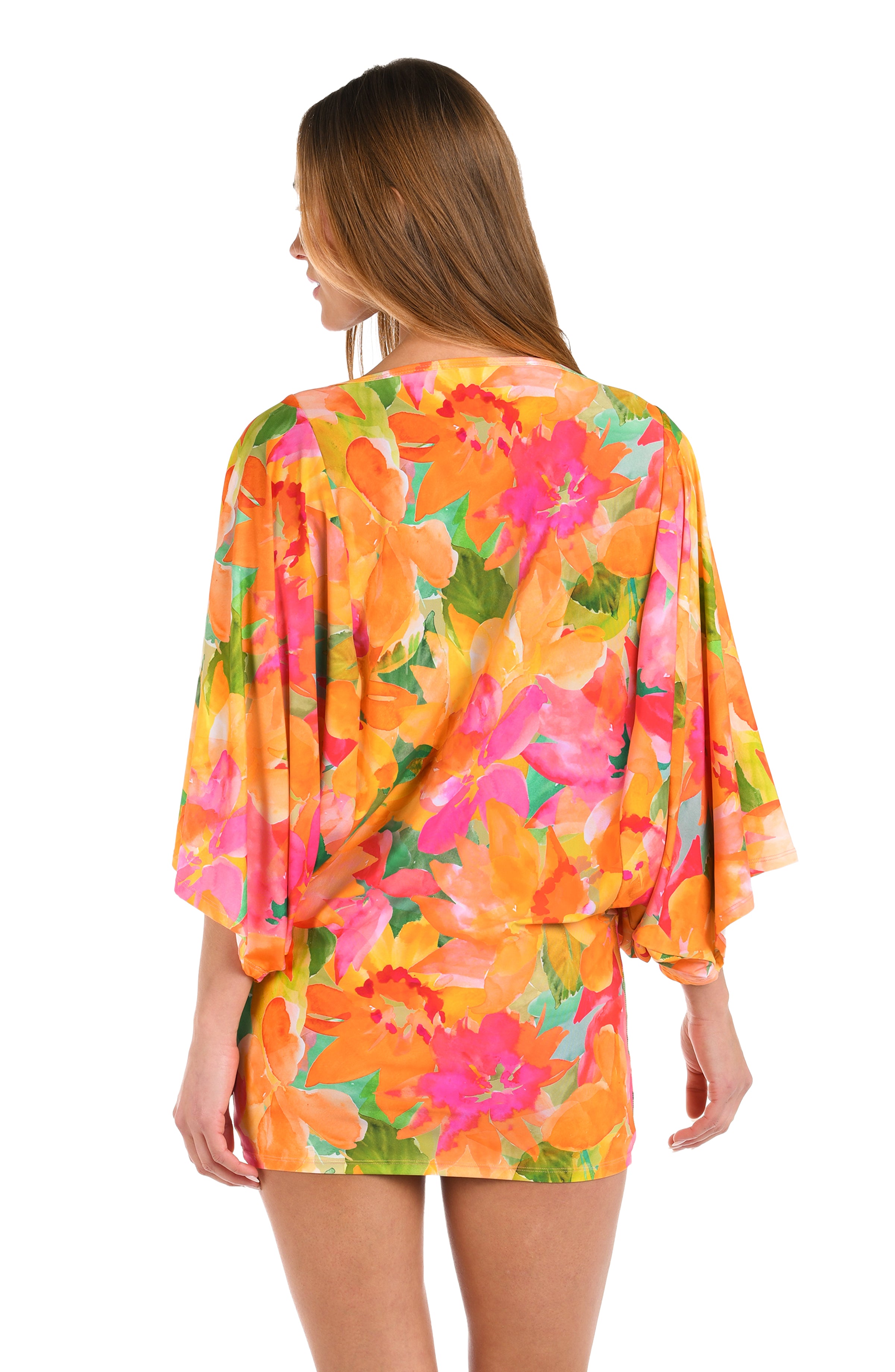 Back image of model wearing a scoop neck tunic cover up, with a vibrant, multicolor floral print featuring a straight silhouette and butterfly sleeves.