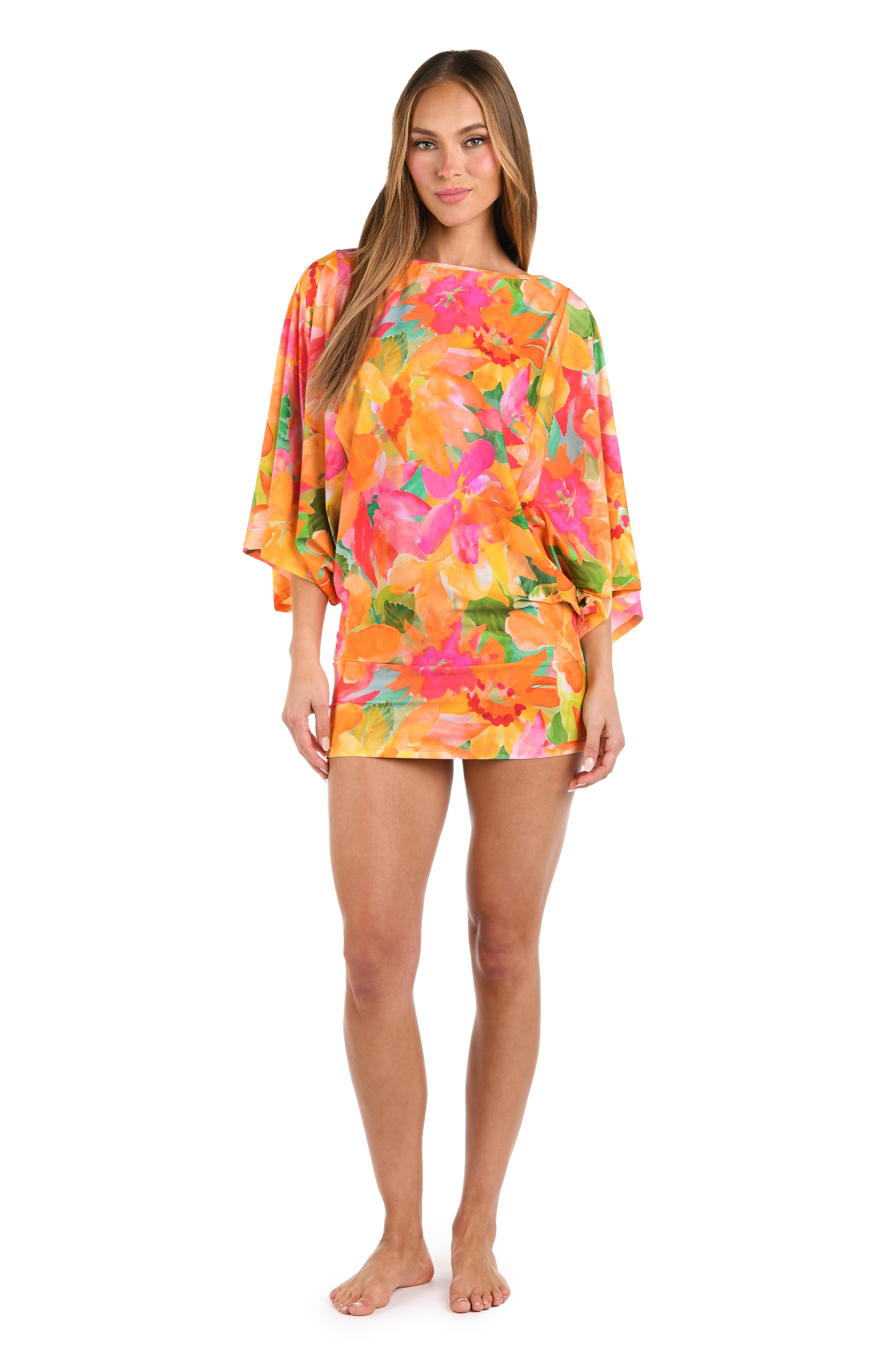 Full body front image of model wearing a scoop neck tunic cover up, with a vibrant, multicolor floral print featuring a straight silhouette and butterfly sleeves.
