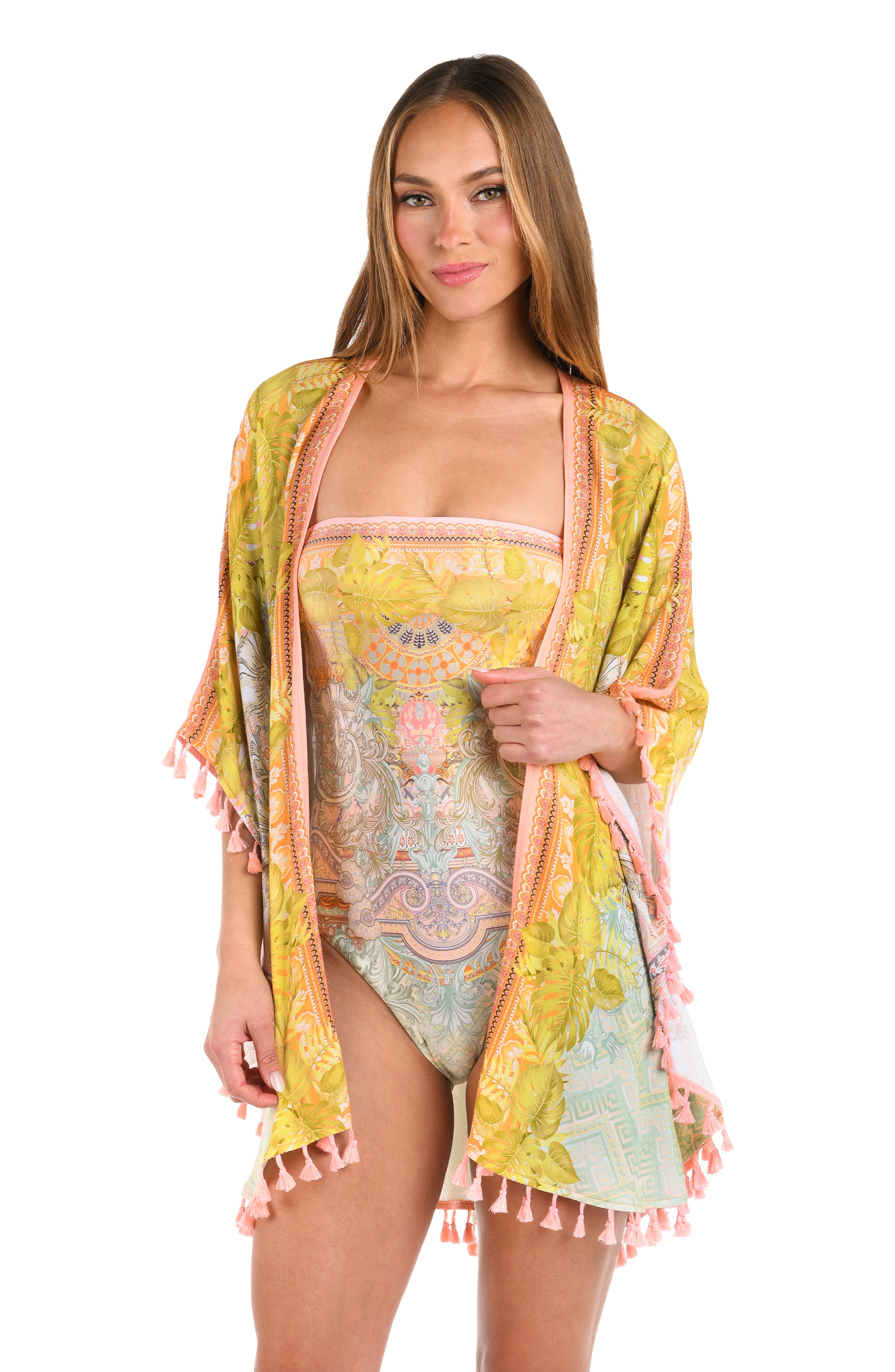 Front image of model wearing a multi-colored yellow and orange patterned kimono cover up trimmed with tassels.