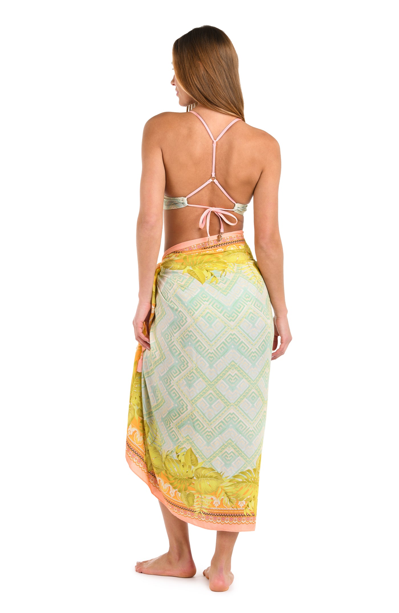 
                  
                    Full body back image of model wearing a multi-colored pastel yellow, green, and peach patterned pareo wrap cover up with a matching bikini. 
                  
                