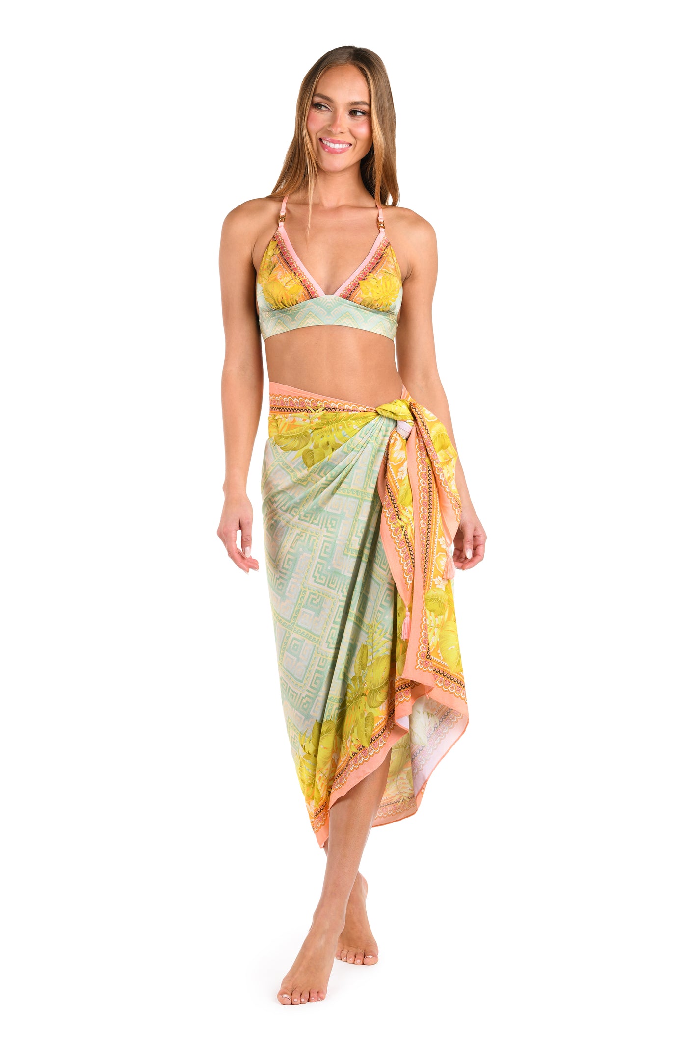 
                  
                    Full body front image of model wearing a multi-colored pastel yellow, green, and peach patterned pareo wrap cover up with a matching bikini. 
                  
                