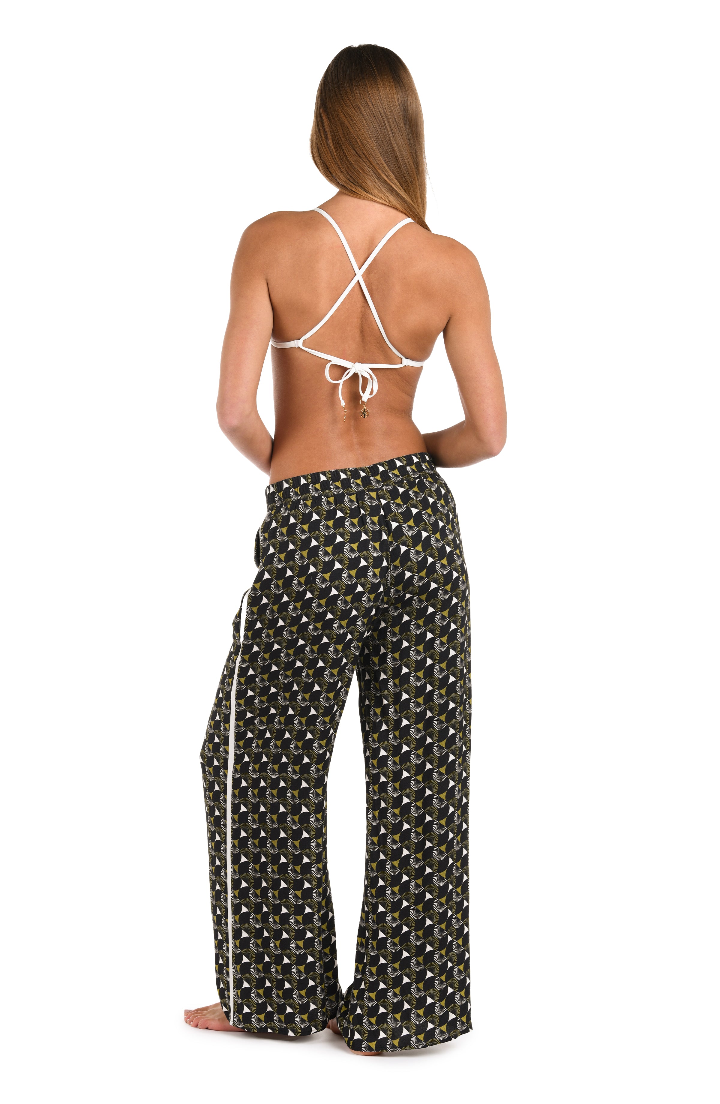 Full body back image of model wearing a black and white geometric printed beach pant cover up. 
