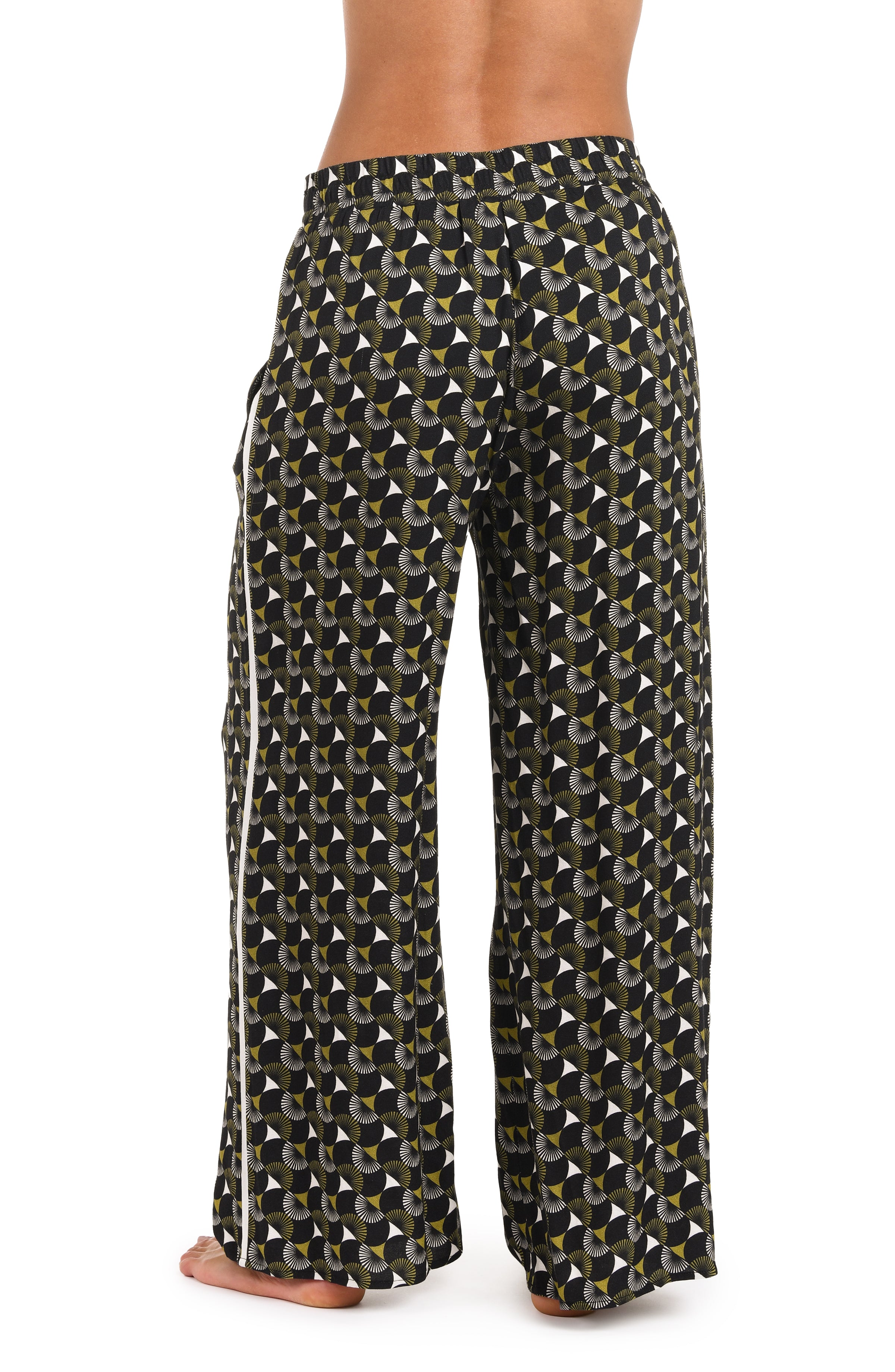 Back image of model wearing a black and white geometric printed beach pant cover up. 