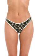 Front image of model wearing a reversible French cut bikini bottom: one side features a solid olive green color with white trim, while the other side showcases a bold black and white geometric print. 