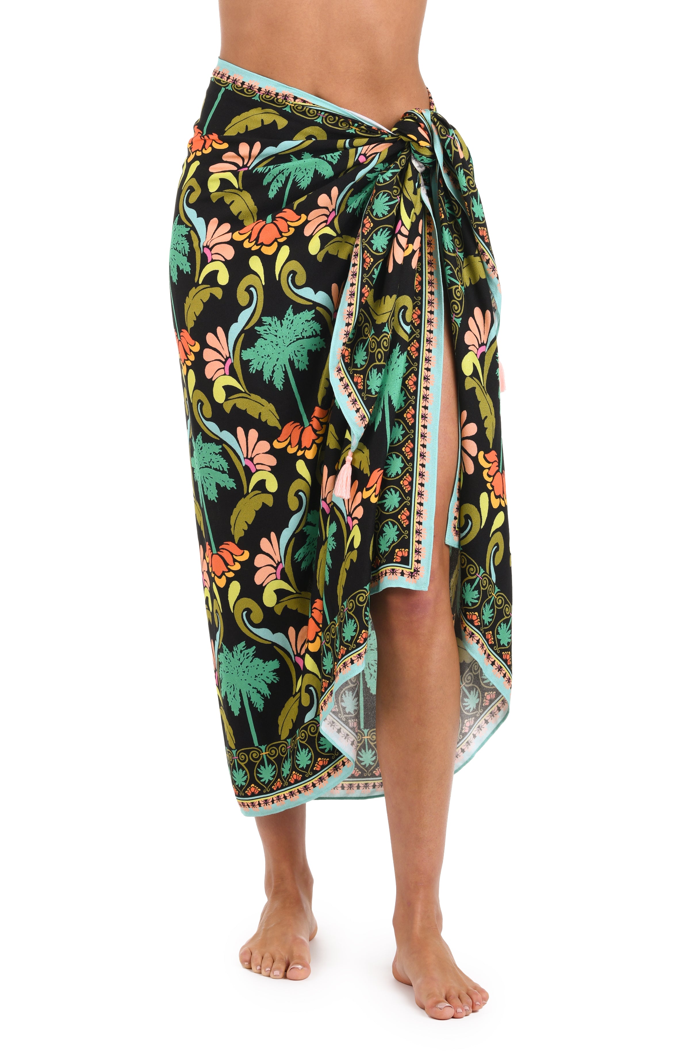 Front image of model wearing a multi-colored pareo wrap cover up with a tropical-inspired design. 