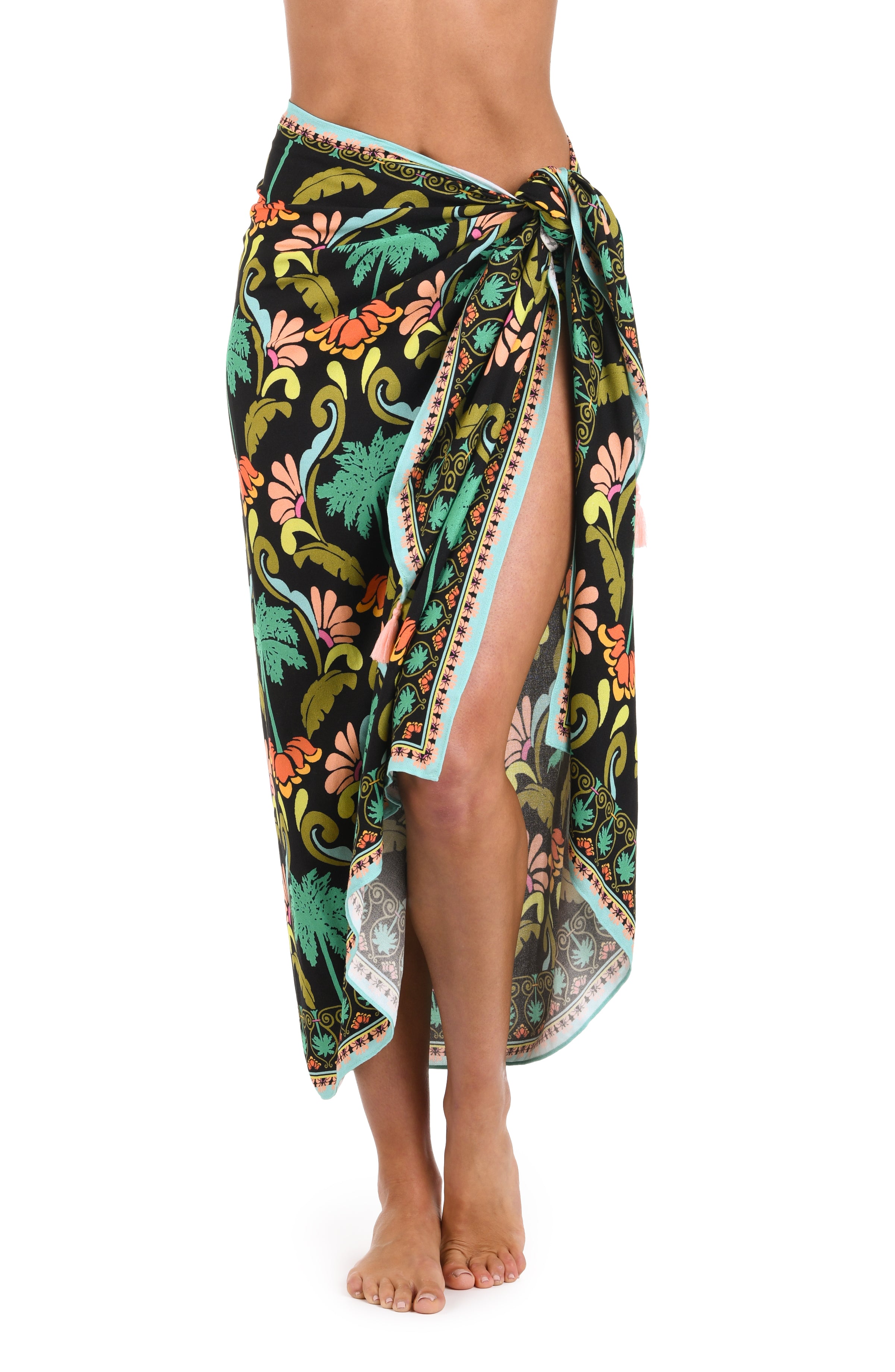 Front image of model wearing a multi-colored pareo wrap cover up with a tropical-inspired design. 