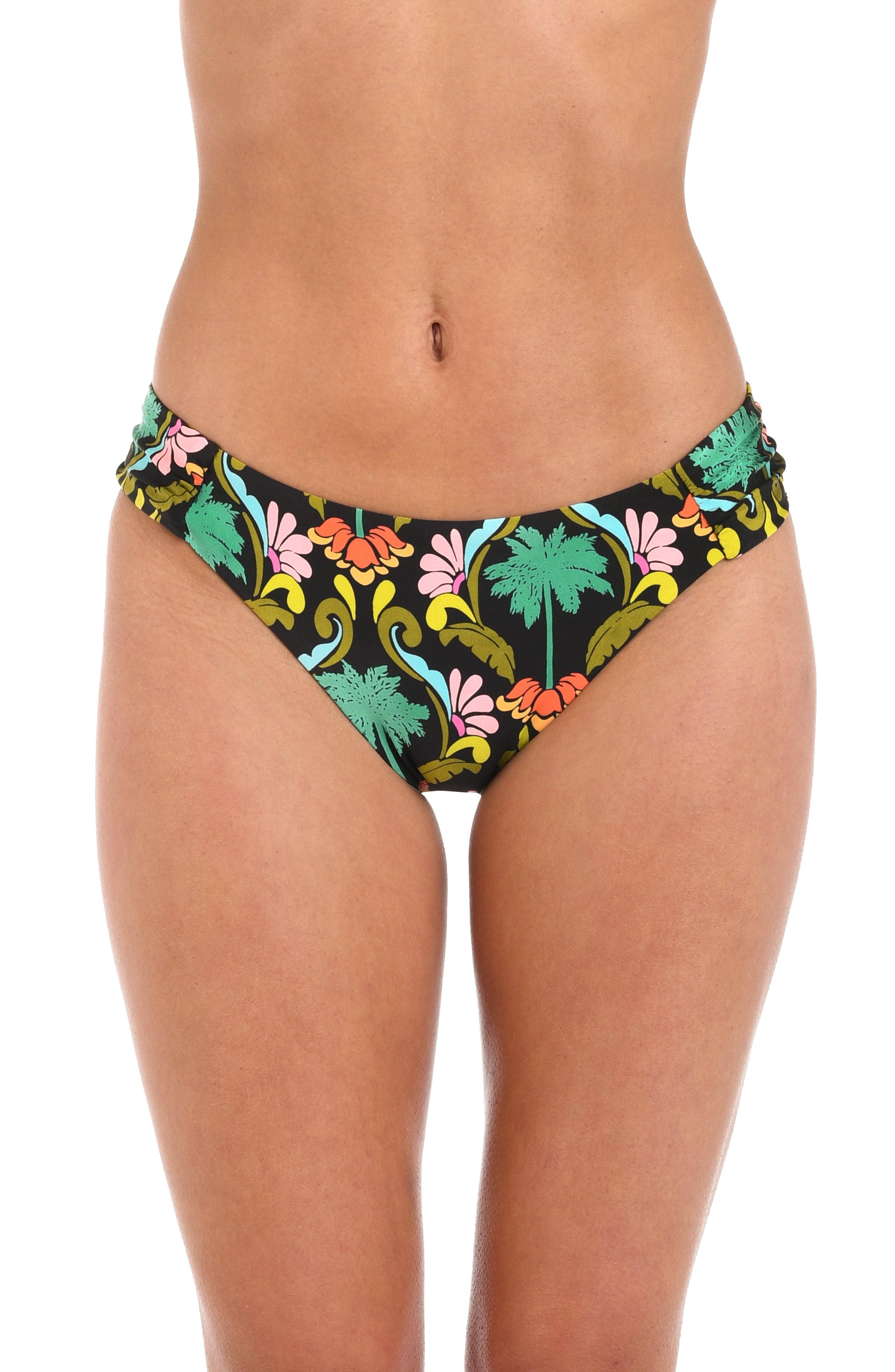 Front image of model wearing a multi-colored side shirred hipster bikini bottom with a tropical-inspired design. 