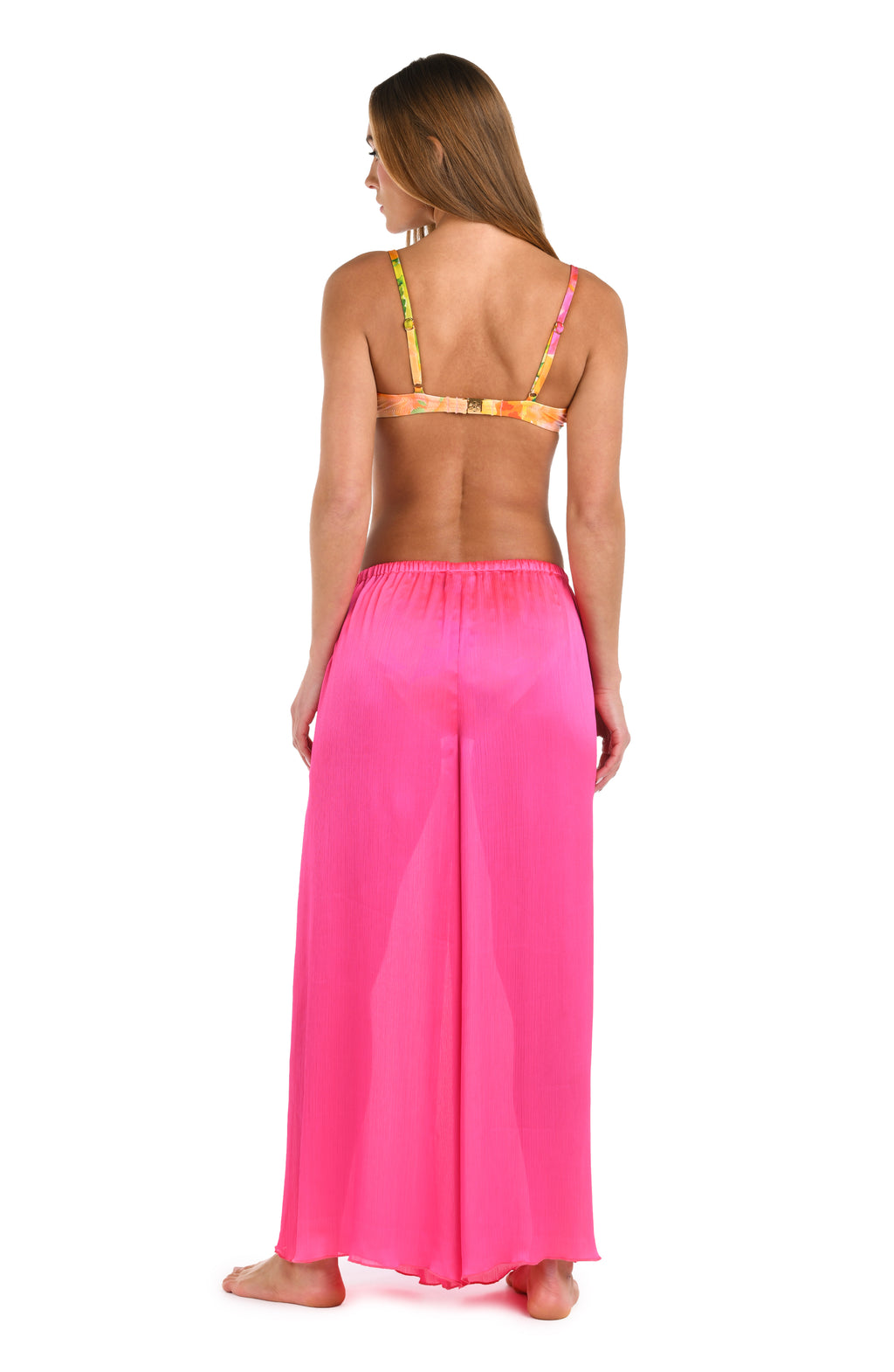 Full back body image of model wearing a solid bright pink crinkle pant cover up.       