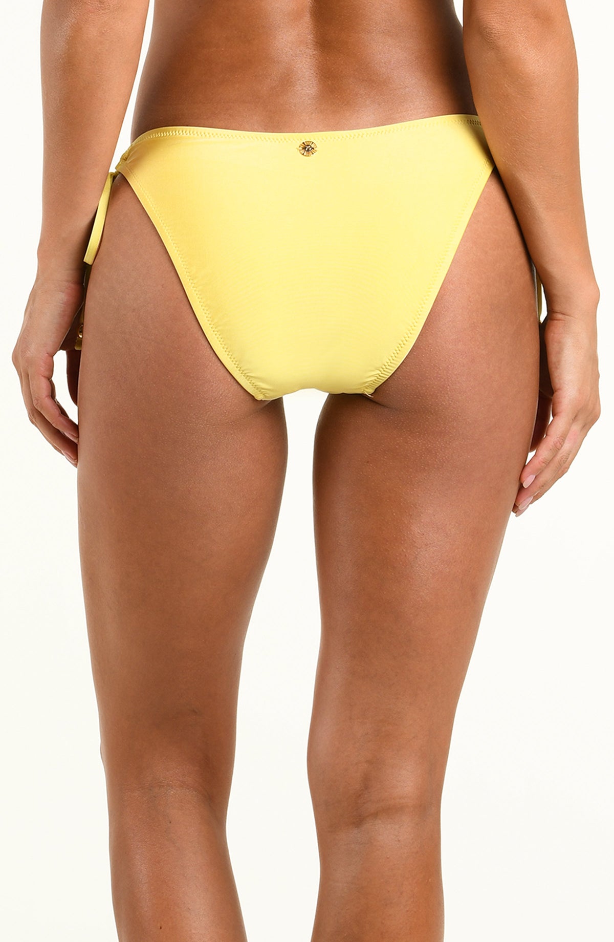 A close-up back view of a model wearing a bright yellow bikini bottom against a plain white background.