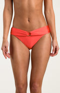 Bright orange bikini bottom with a gold ring detail on a white background