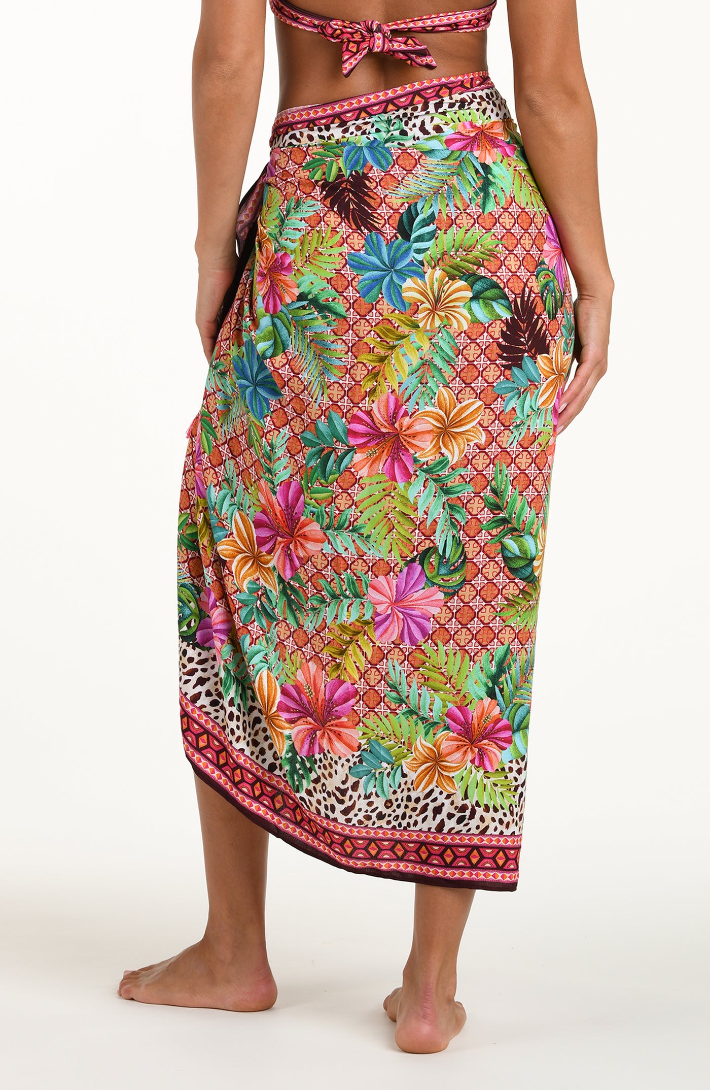 
                  
                    Back image of model wearing a multicolored tropical and leopard printed pareo wrap featuring a tie side. 
                  
                