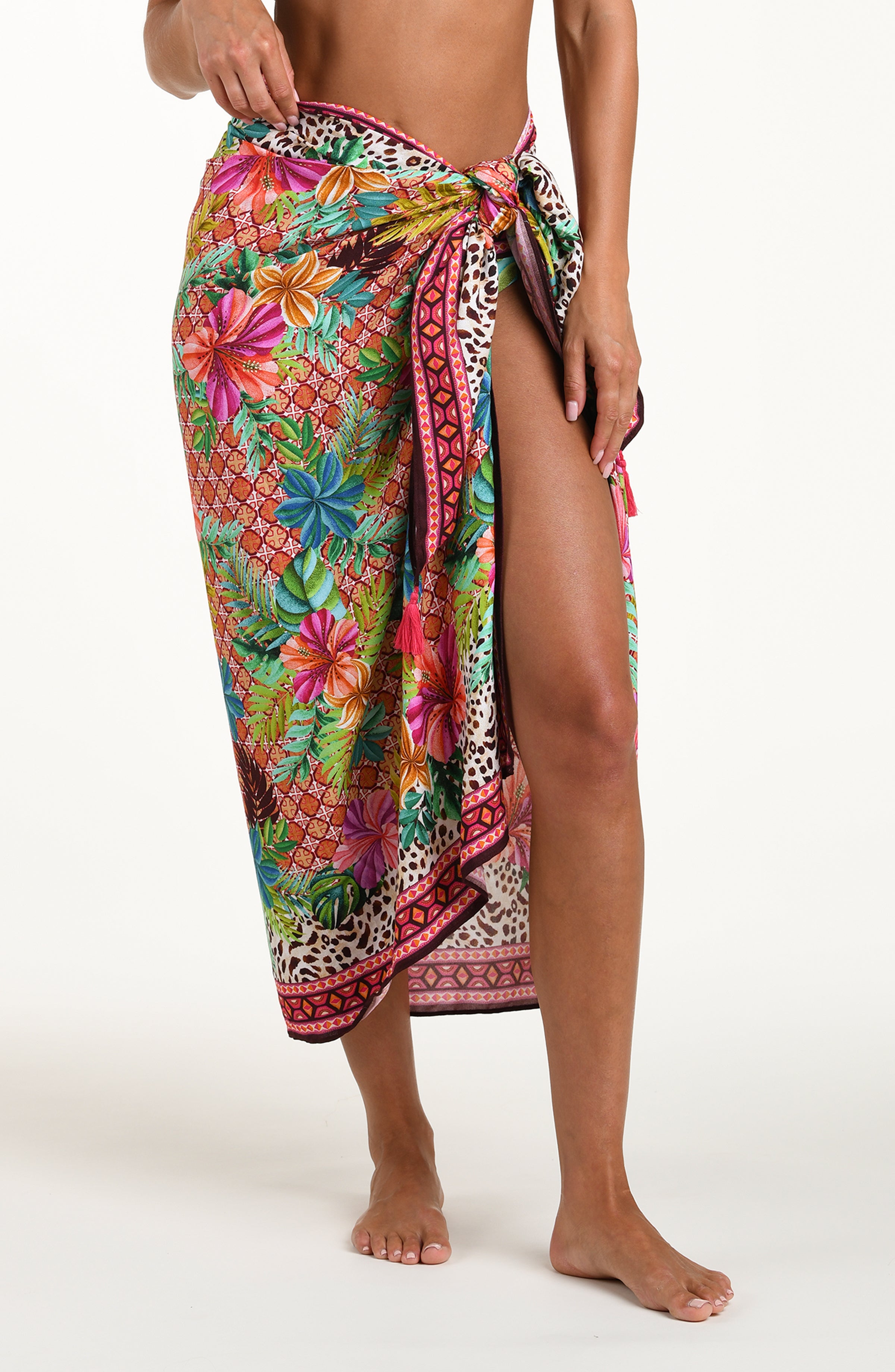 Front image of model wearing a multicolored tropical and leopard printed pareo wrap featuring a tie side. 